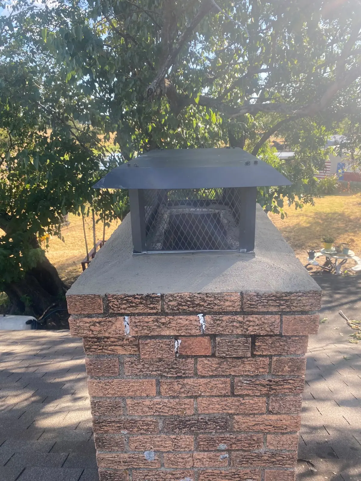 New chimney cap installed on a brick chimney by Dallas Chimney Care