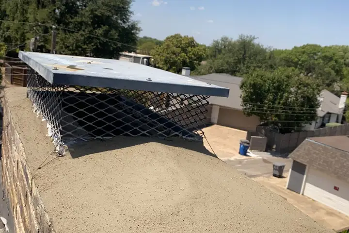 New concrete chimney crown and cap on a brick chimney in Dallas
