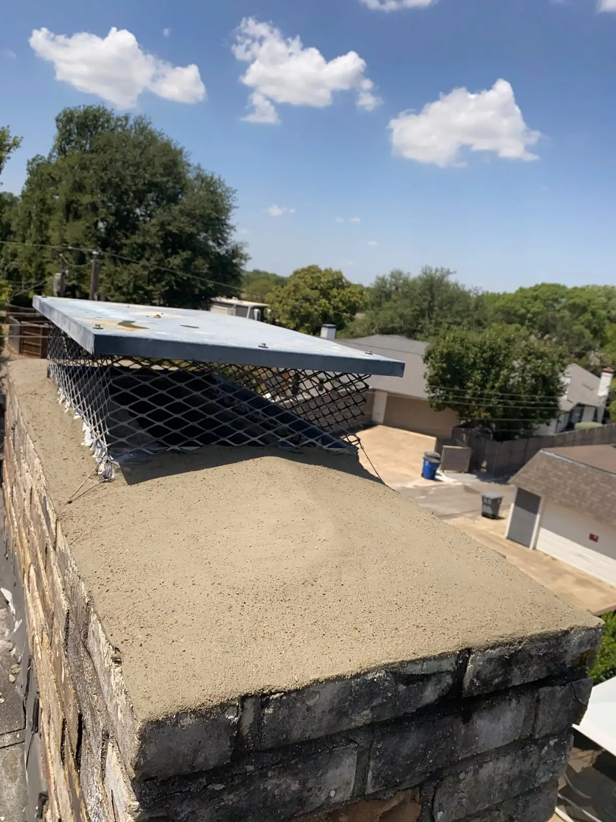 New concrete chimney crown and cap on a brick chimney in Dallas