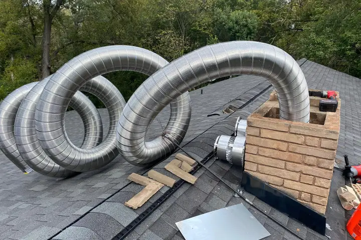 Stainless steel chimney liner ready for installation on a Dallas roof