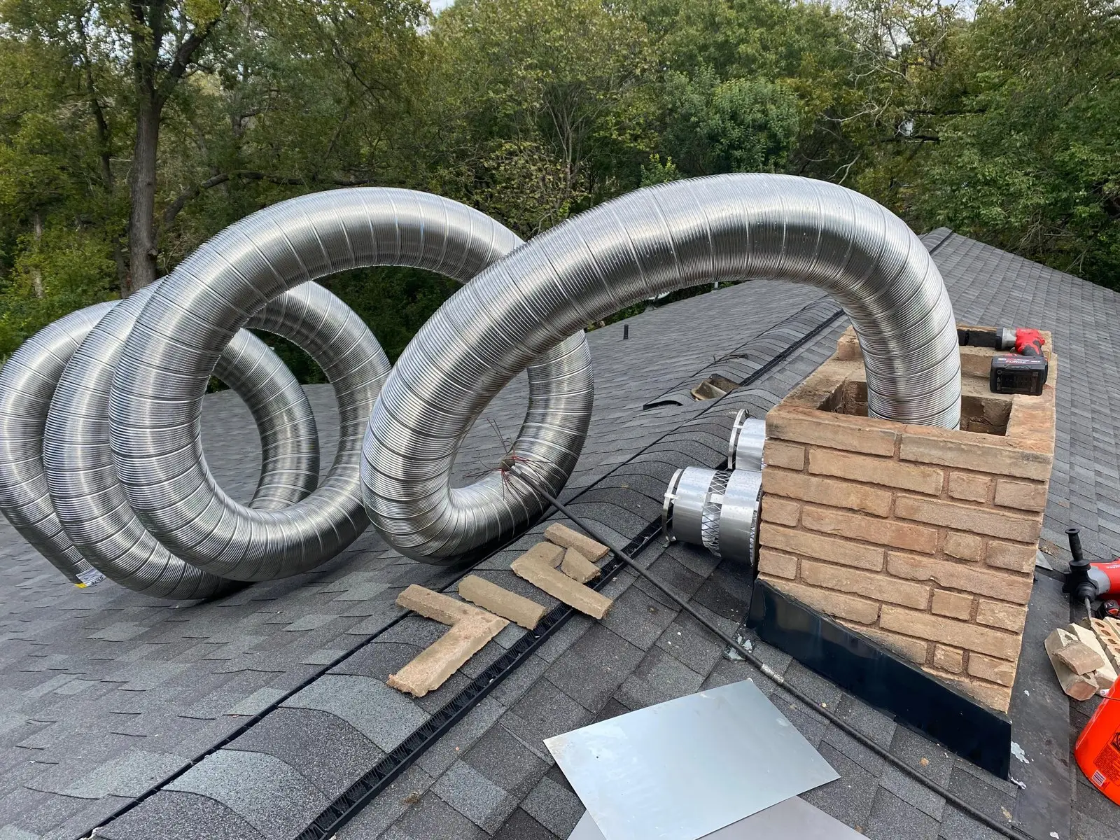 Stainless steel chimney liner ready for installation on a Dallas roof