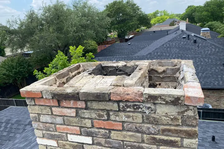 Top of a brick chimney taken down for a rebuild on a Dallas roof