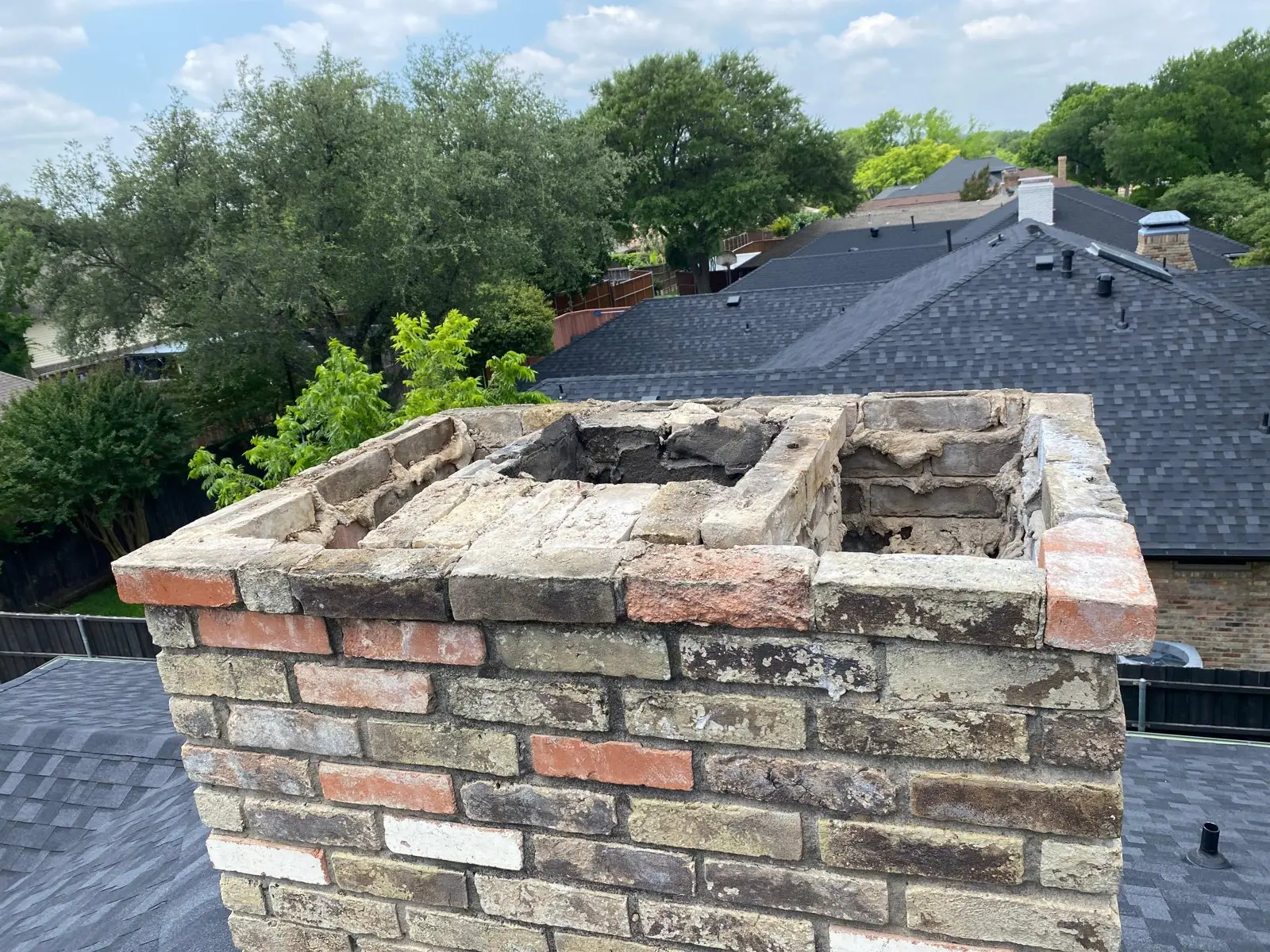 Top of a brick chimney taken down for a rebuild on a Dallas roof