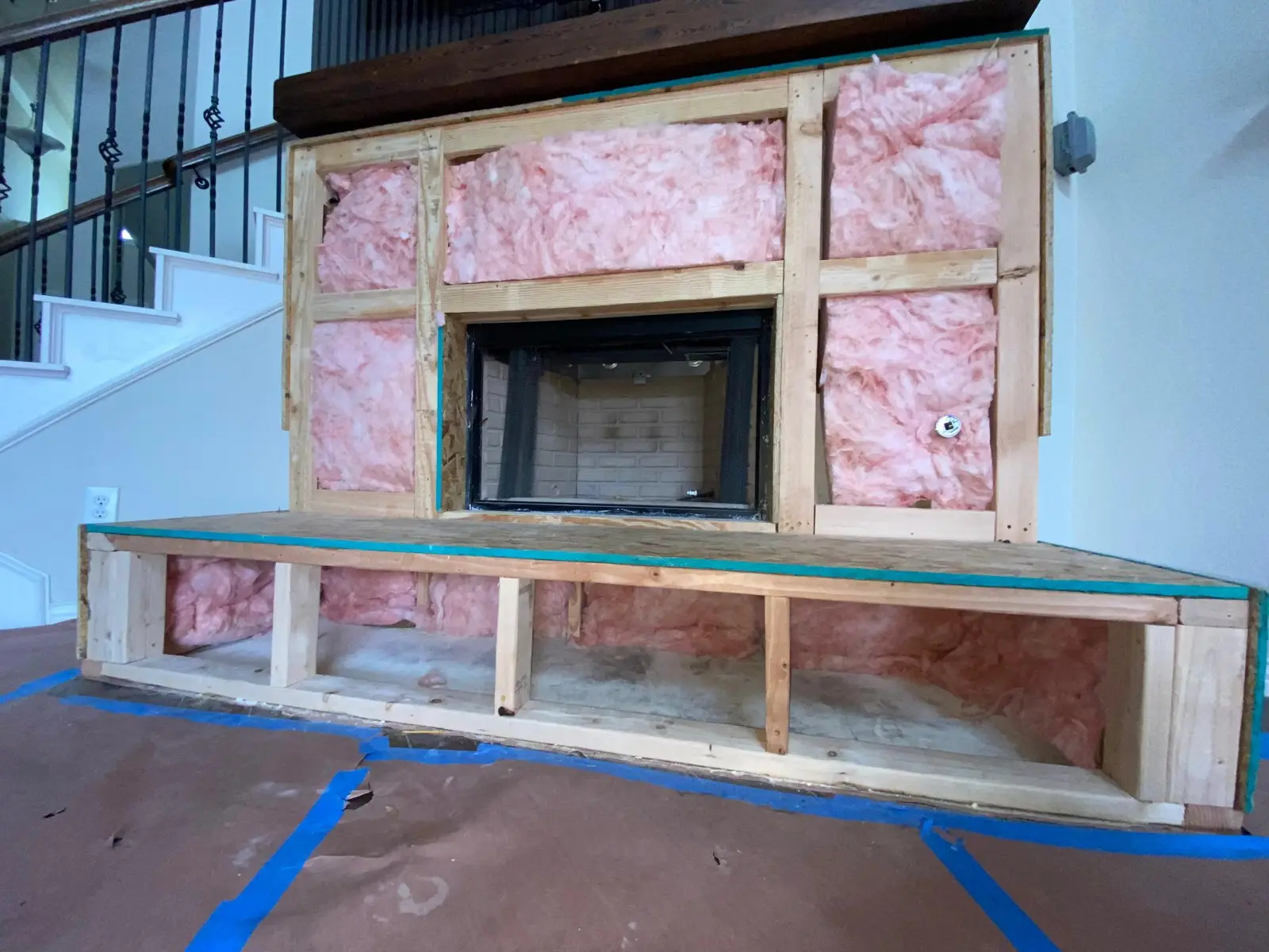 New fireplace insert framed in during an installation in a Dallas home