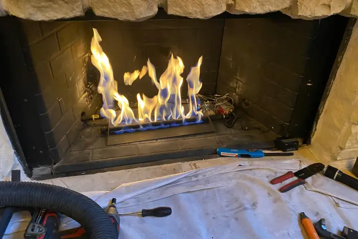 Fireplace burner repair and test by a Dallas Chimney Care technician