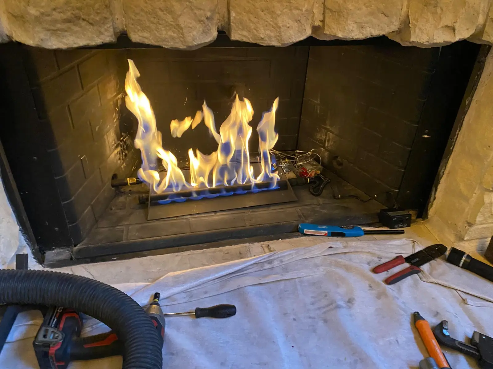 Fireplace burner repair and test by a Dallas Chimney Care technician
